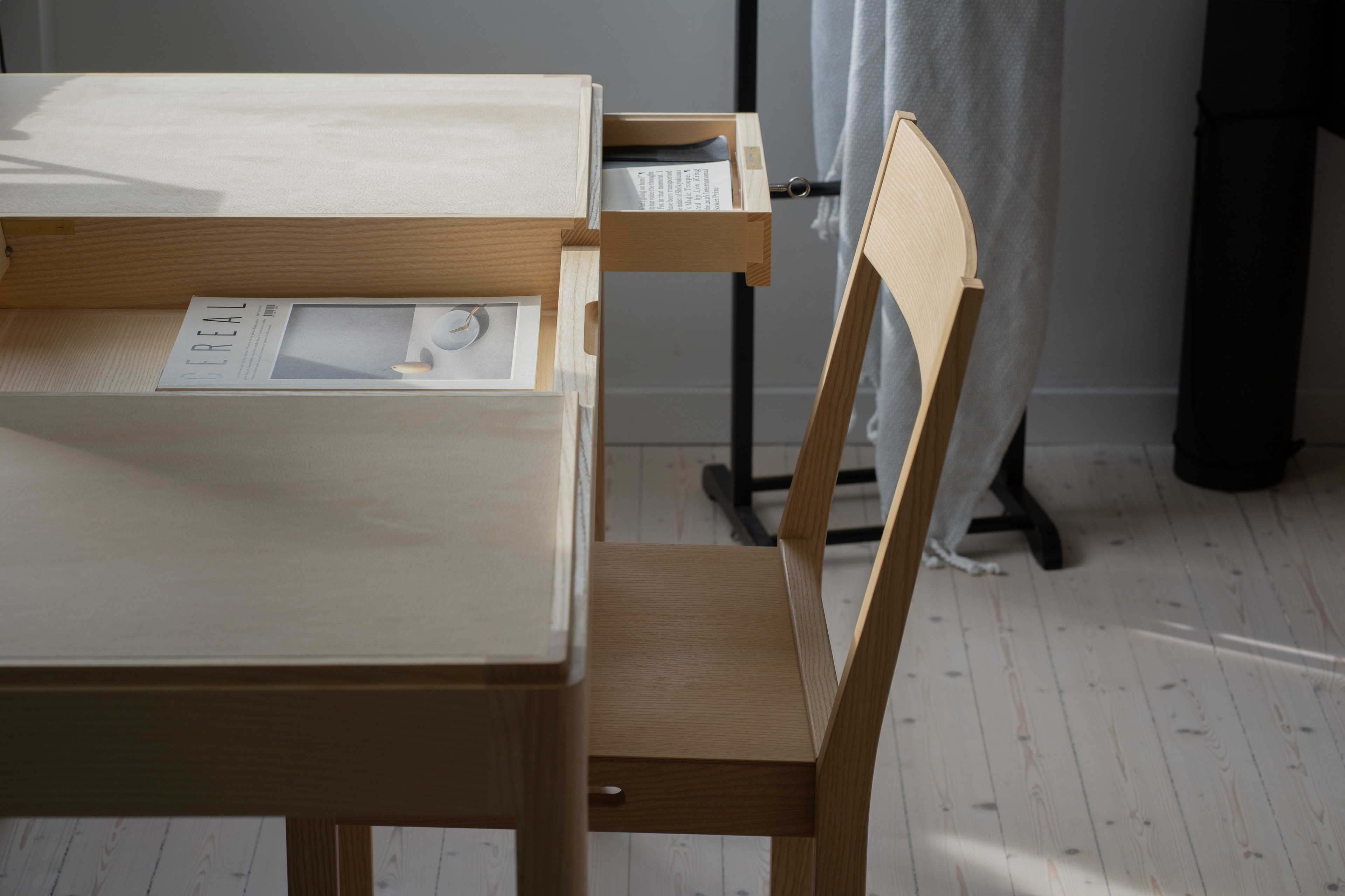 Journalist’s Desk in morning light, with a chair and an open drawer