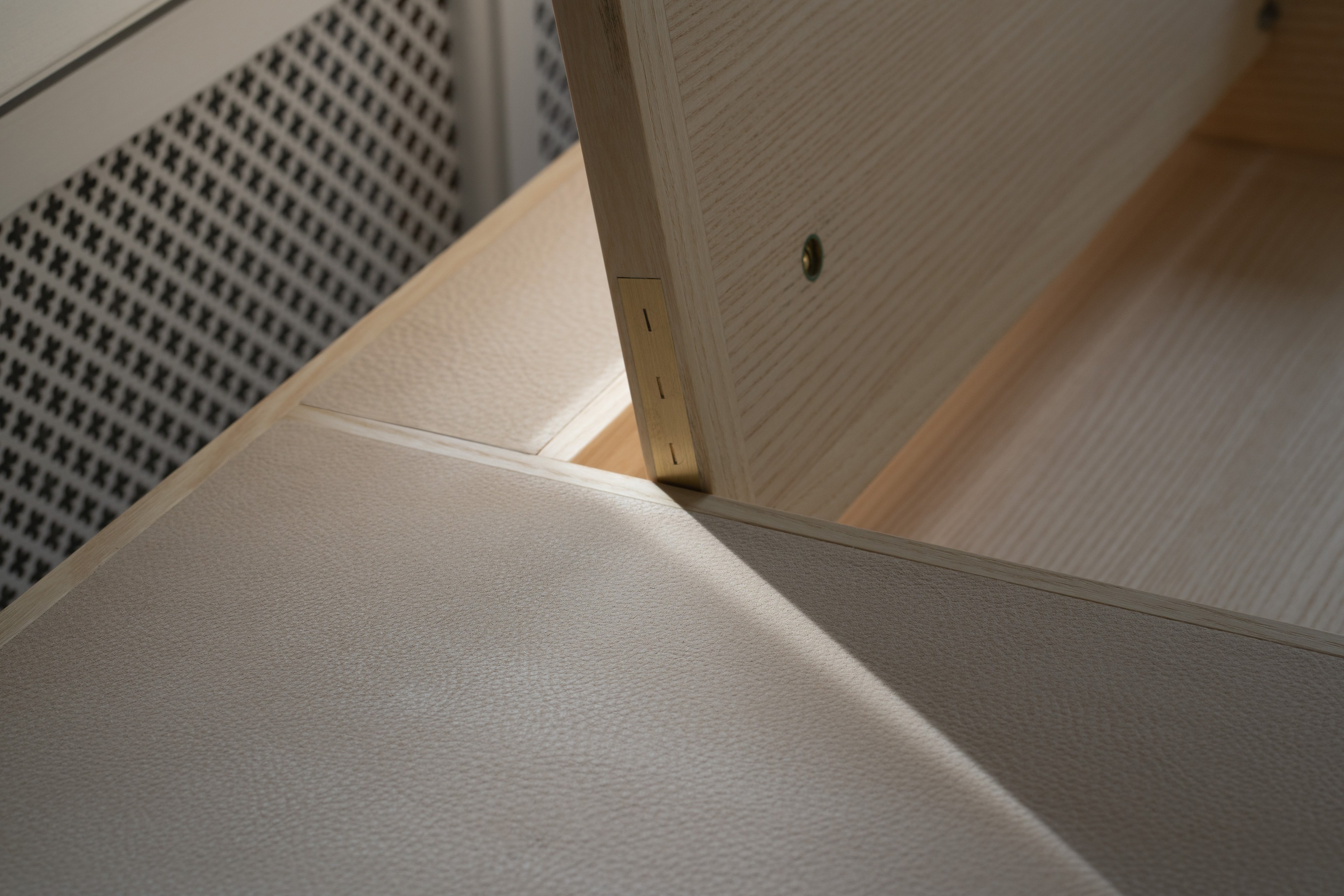 Detail of the leather surface against the brass fitting on the door
