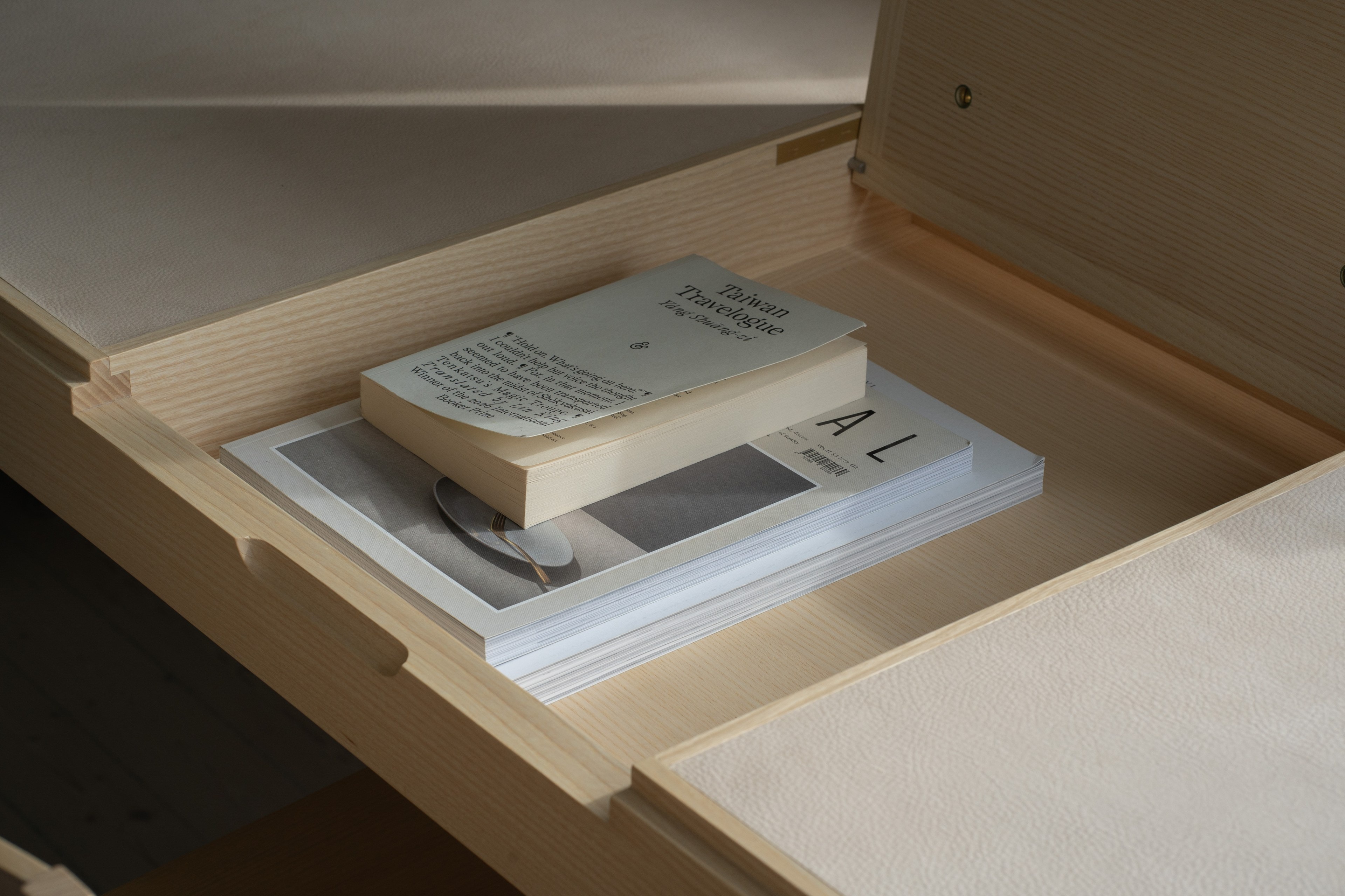 Open drawer in the Journalist’s Desk, books resting on the birch drawer bottom